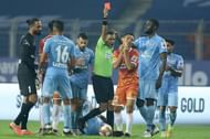 The referee shows a red card to FC Goa's Redeem Tlang for a mistimed sliding challenge